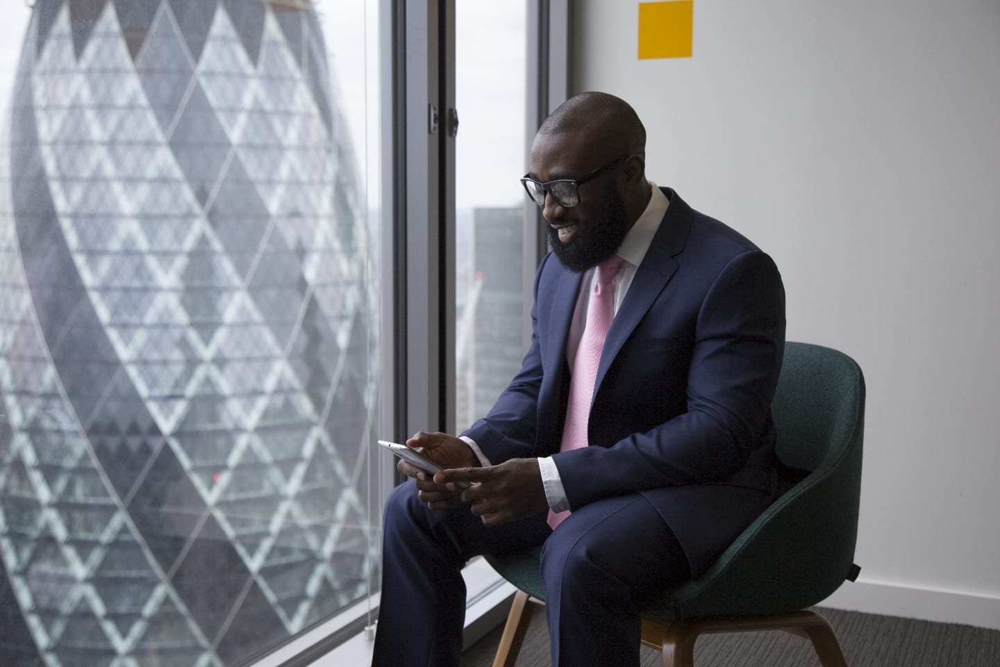 Lee Sam seated by a London office window