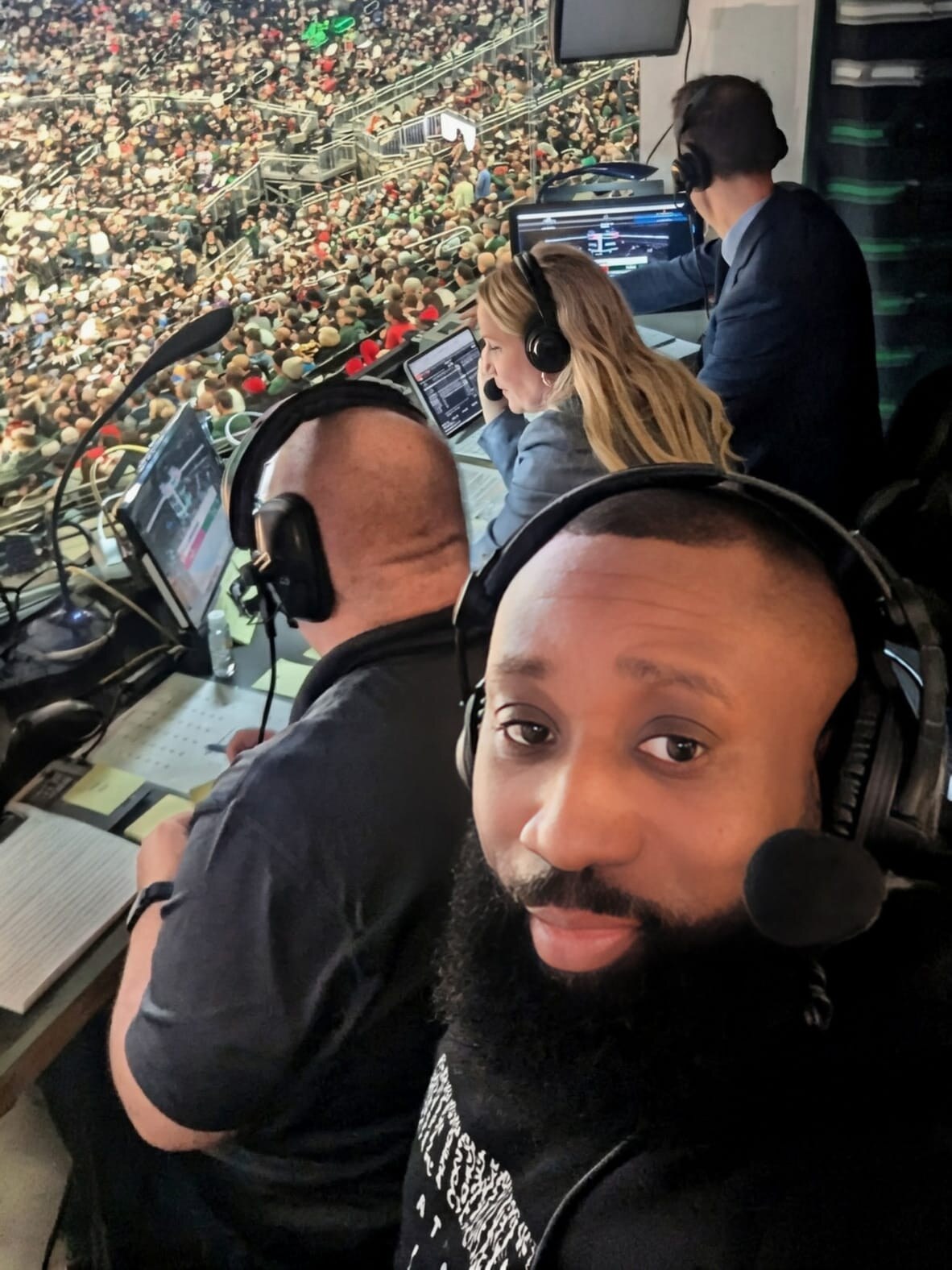 Lee Sam wearing a headset in a basketball broadcast booth